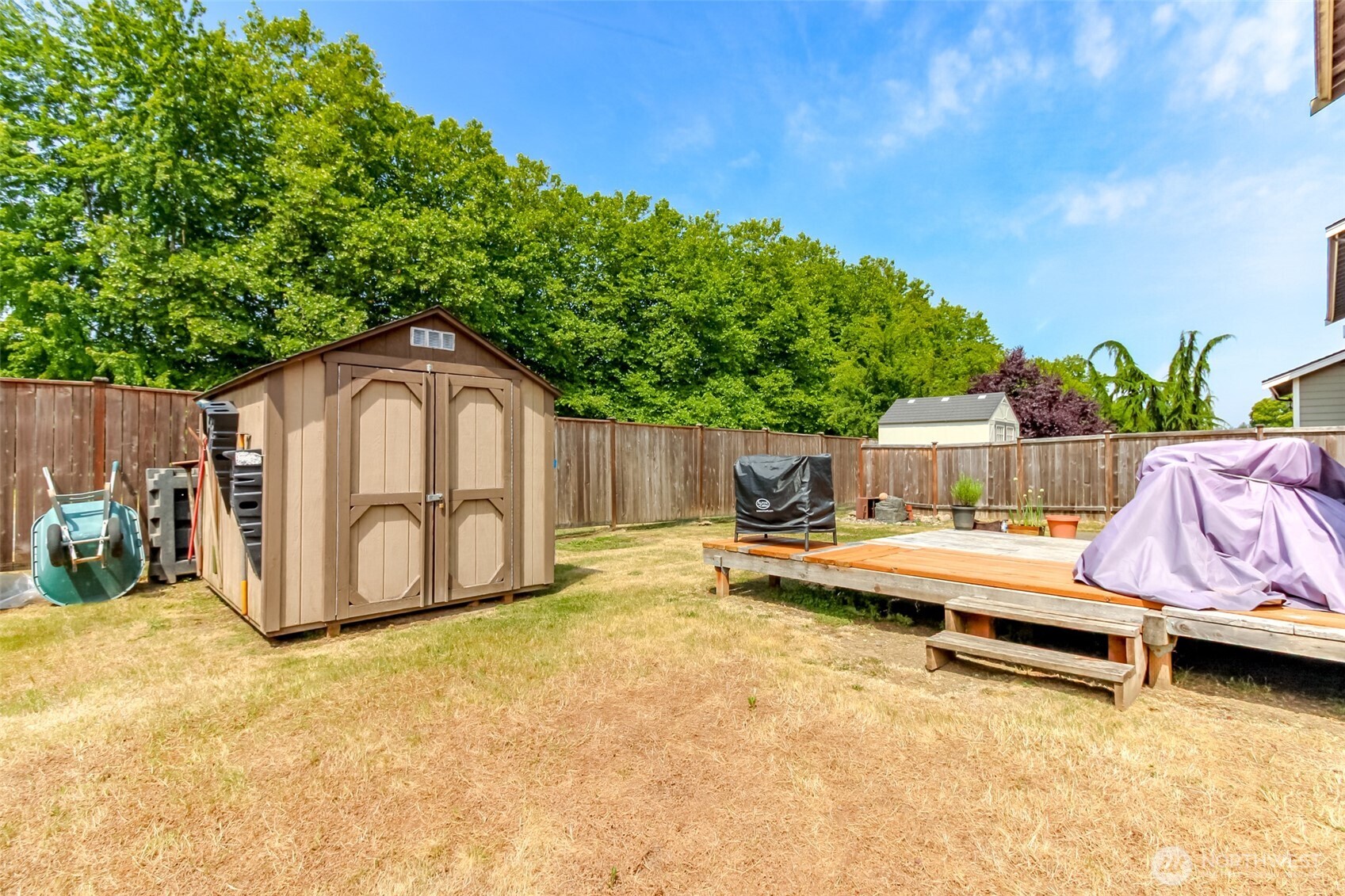 1605 Riddell Avenue Northeast Orting, WA 98360 - Photo 33 of 35 a view of backyard with tub and trees in the background