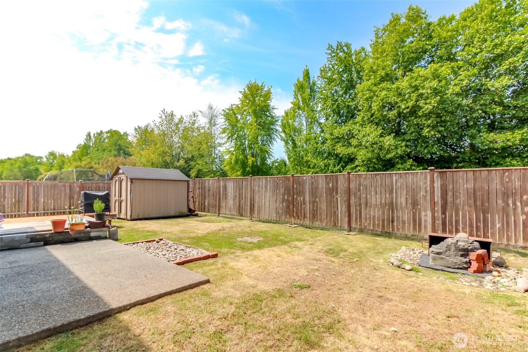 1605 Riddell Avenue Northeast Orting, WA 98360 - Photo 35 of 35 a view of a backyard with a car parked in the background