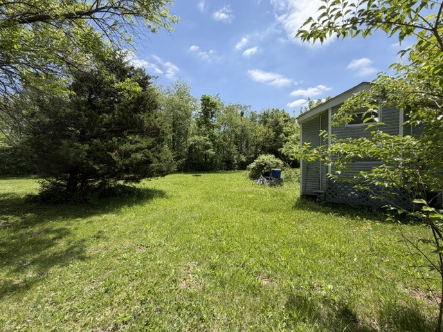 2795 East 28th Road Marseilles, IL 61341 - Photo 25 of 64 a backyard of a house with lots of green space and plants