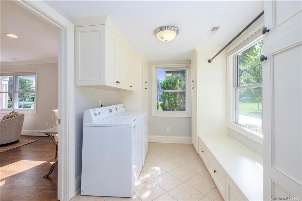 635 Marsh Road Charlotte, NC 28209 - Photo 11 of 48 a utility room with cabinets washer and dryer