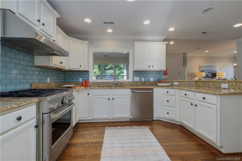 635 Marsh Road Charlotte, NC 28209 - Photo 20 of 48 a kitchen with a sink stove and cabinets