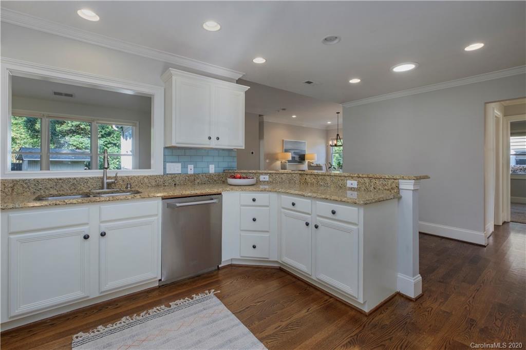 635 Marsh Road Charlotte, NC 28209 - Photo 21 of 48 a kitchen with a sink window and cabinets
