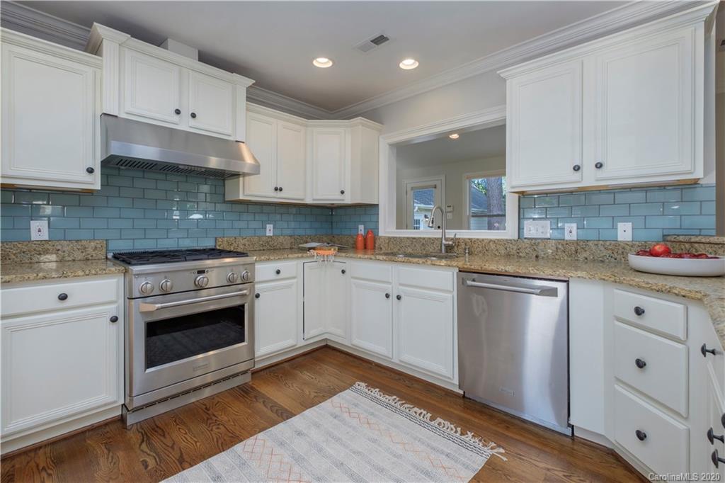 635 Marsh Road Charlotte, NC 28209 - Photo 23 of 48 a kitchen with granite countertop white cabinets and white appliances
