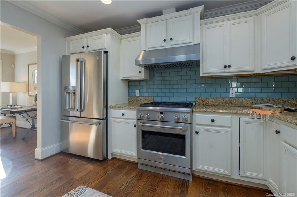 635 Marsh Road Charlotte, NC 28209 - Photo 24 of 48 a kitchen with stainless steel appliances white cabinets and a refrigerator