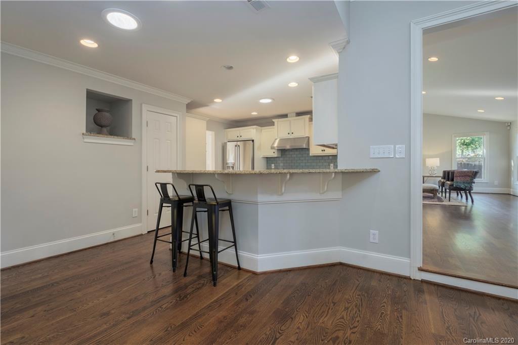 635 Marsh Road Charlotte, NC 28209 - Photo 25 of 48 a view of a kitchen with dining table chairs and wooden floor