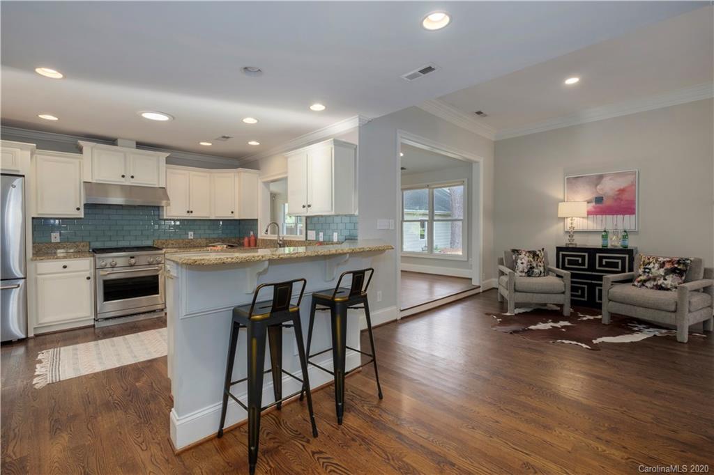 635 Marsh Road Charlotte, NC 28209 - Photo 26 of 48 a kitchen with a table chairs microwave and cabinets