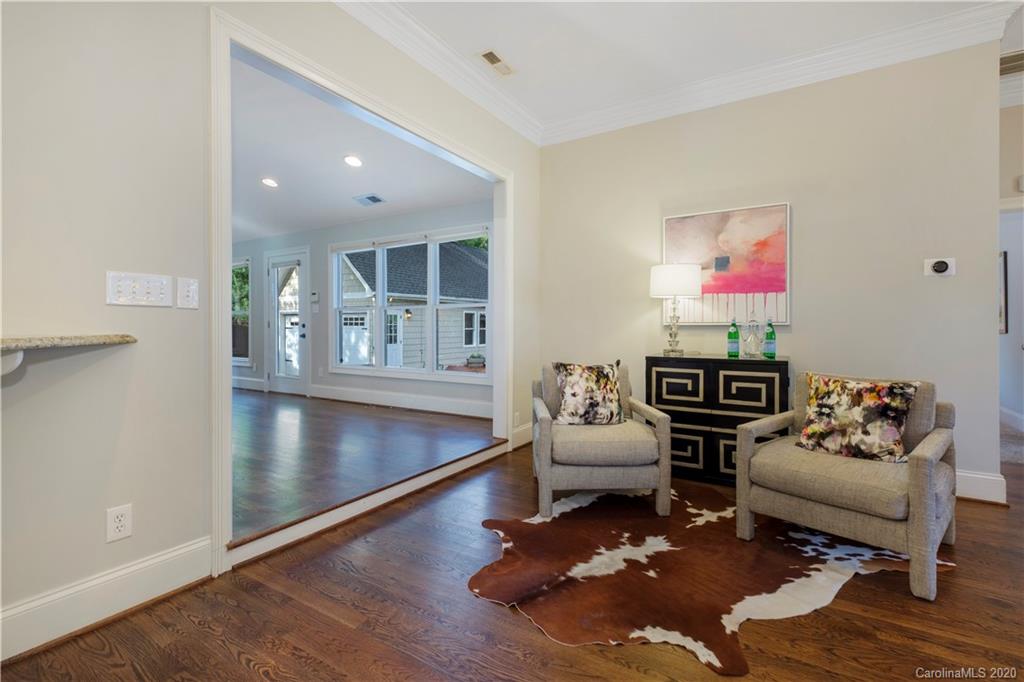 635 Marsh Road Charlotte, NC 28209 - Photo 30 of 48 a living room with furniture and a floor to ceiling window