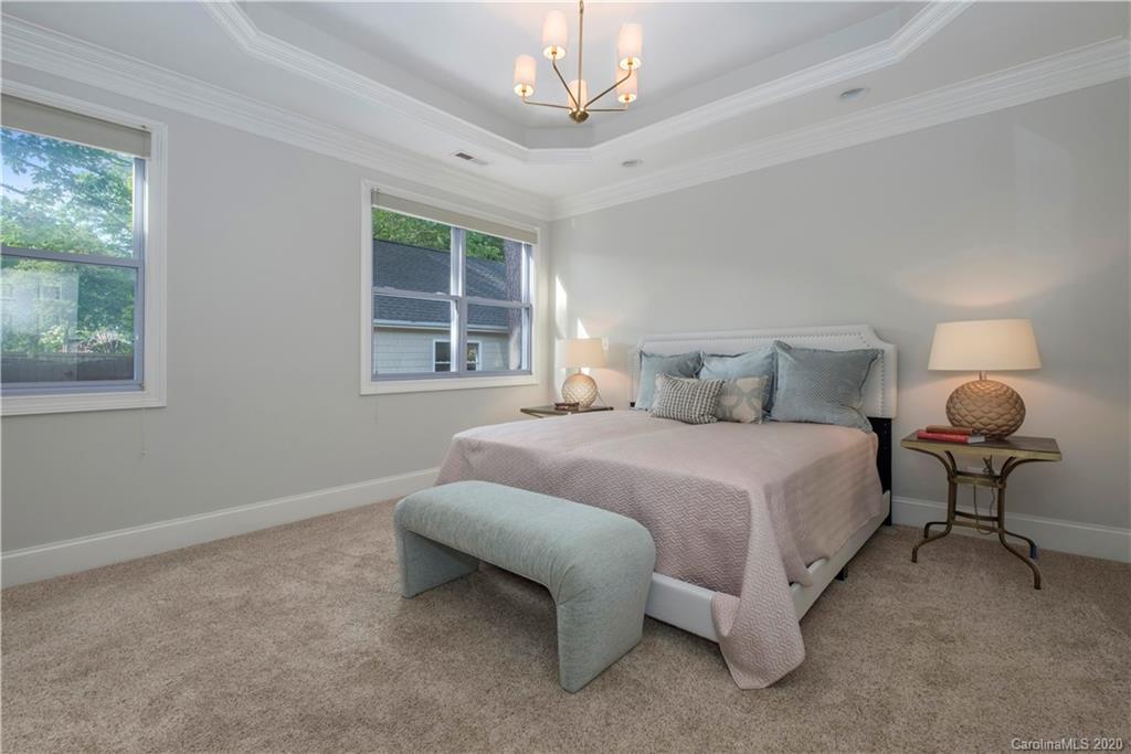 635 Marsh Road Charlotte, NC 28209 - Photo 31 of 48 a bedroom with a bed chandelier and window