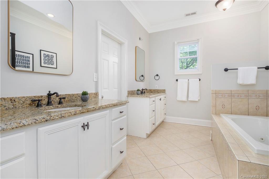 635 Marsh Road Charlotte, NC 28209 - Photo 36 of 48 a spacious bathroom with a granite countertop sink mirror and bathtub