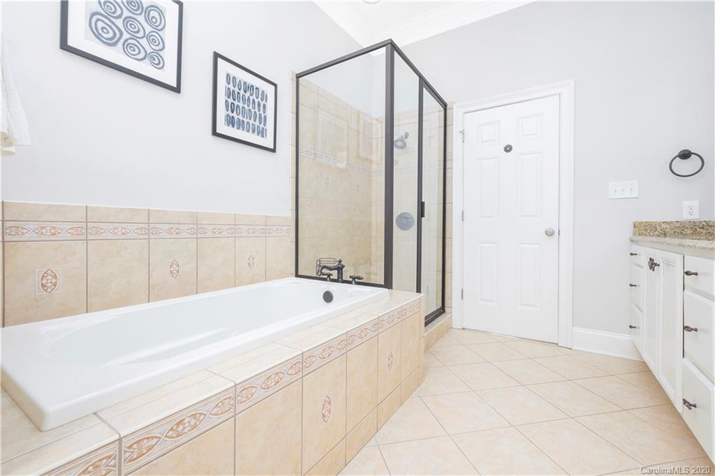 635 Marsh Road Charlotte, NC 28209 - Photo 38 of 48 a spacious bathroom with a tub shower and sink