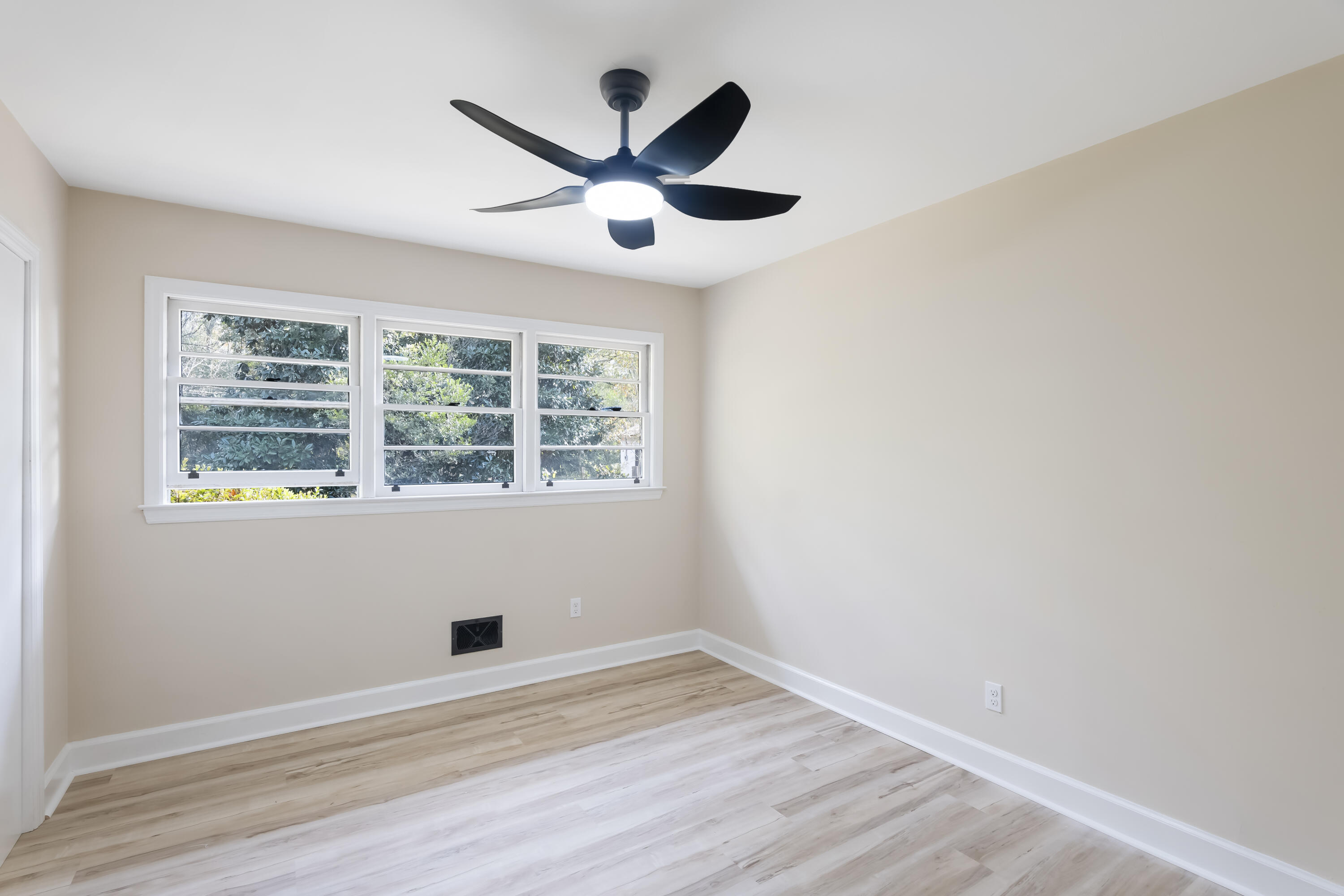 39 Gantt Street Wagener, SC 29164 - Photo 20 of 30 an empty room with wooden floor and windows
