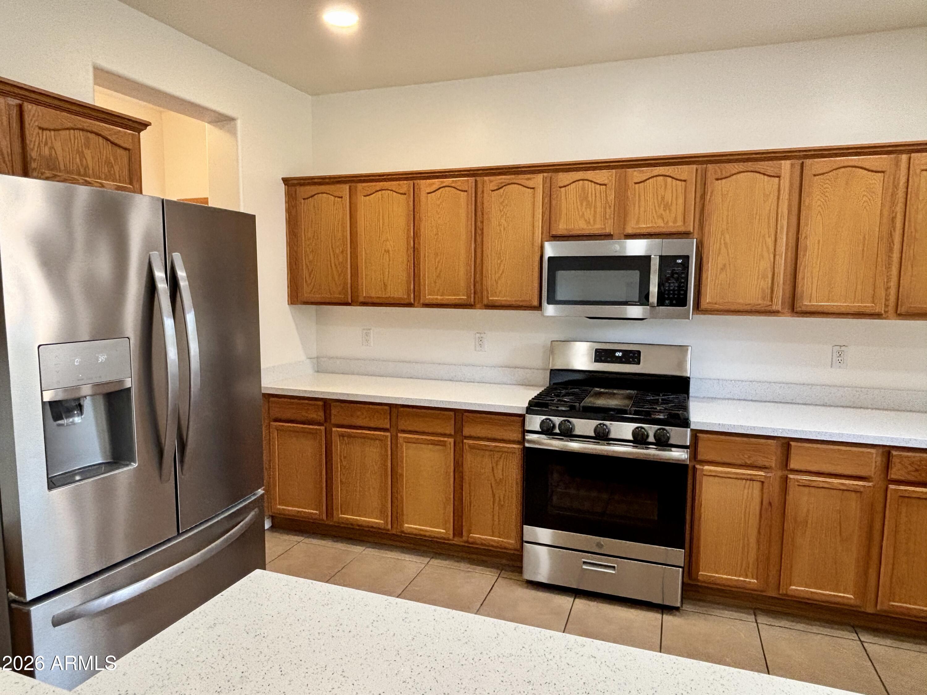 160 North Pottebaum Road Casa Grande, AZ 85122 - Photo 11 of 47 a kitchen with stainless steel appliances granite countertop a refrigerator stove and microwave