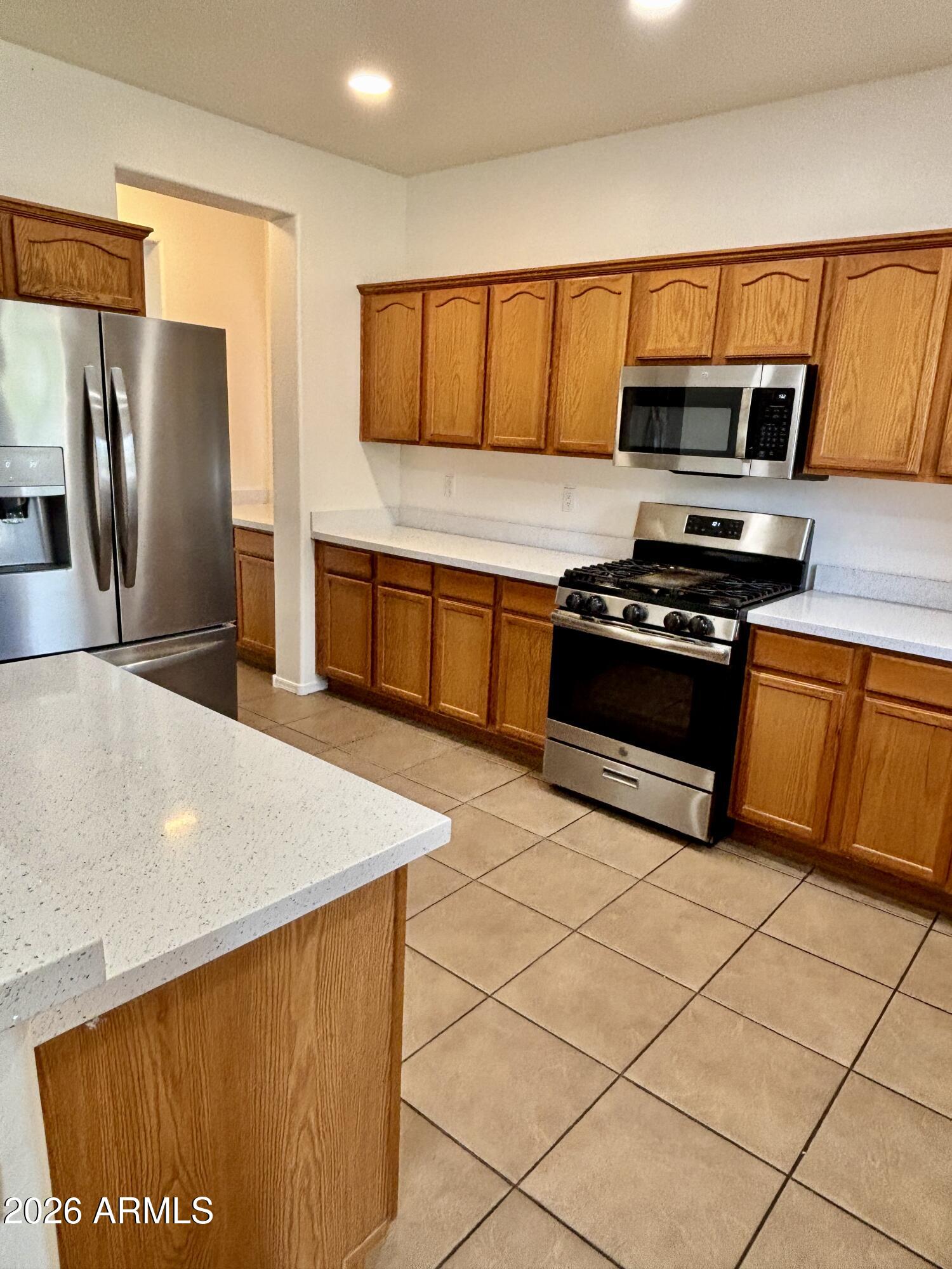 160 North Pottebaum Road Casa Grande, AZ 85122 - Photo 12 of 47 a kitchen with stainless steel appliances a refrigerator sink and stove