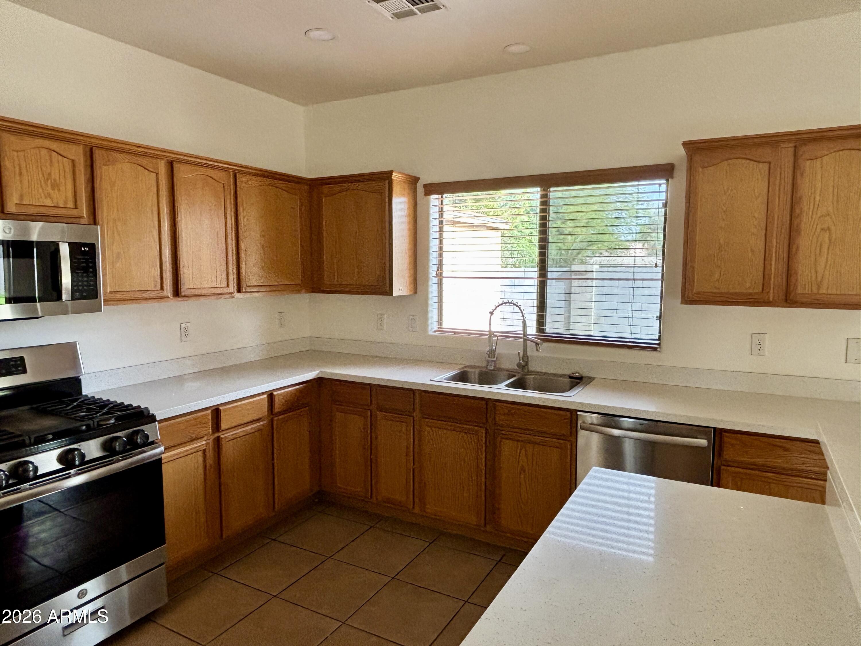 160 North Pottebaum Road Casa Grande, AZ 85122 - Photo 13 of 47 a kitchen with stainless steel appliances granite countertop a sink stove and microwave