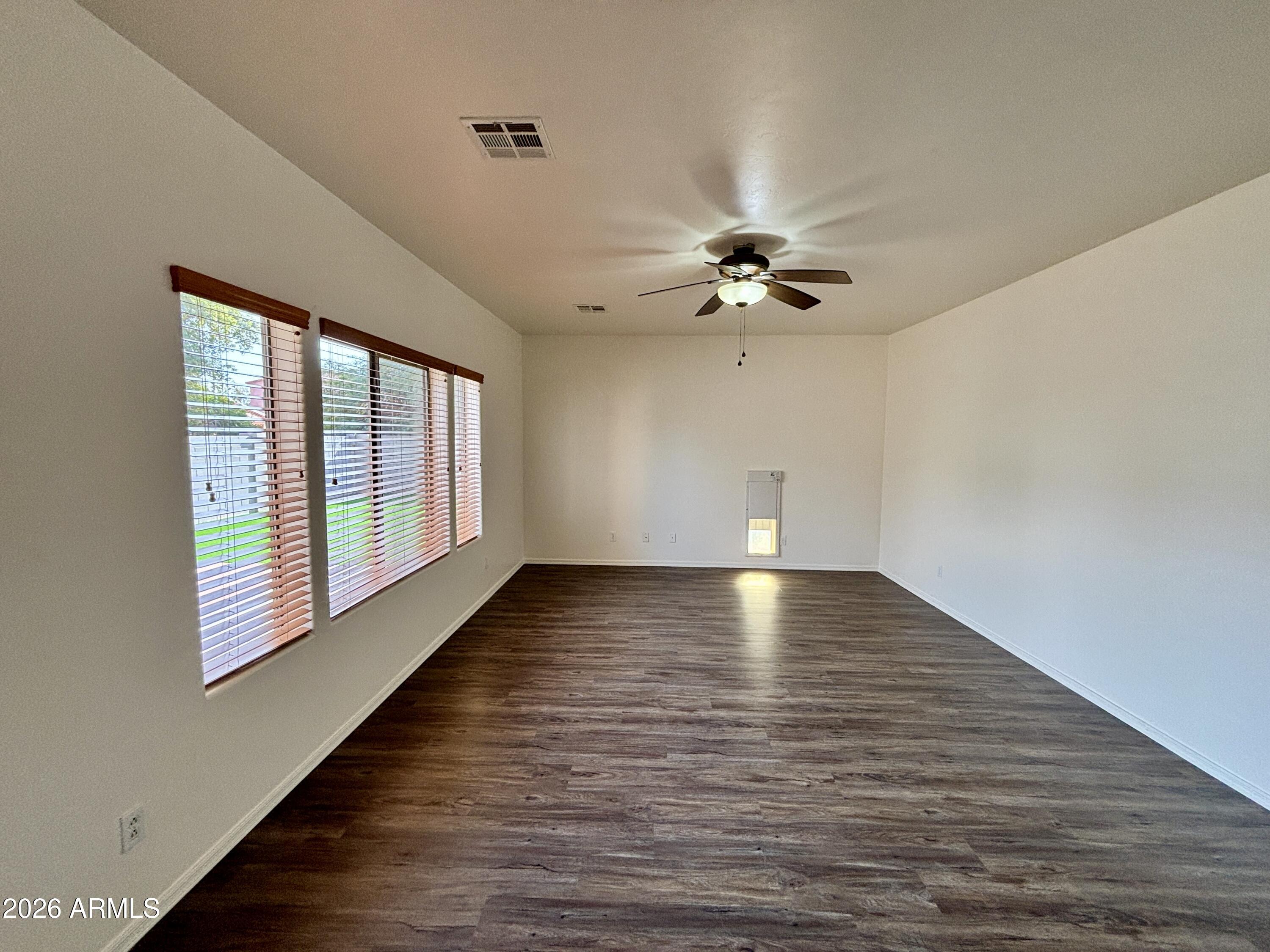 160 North Pottebaum Road Casa Grande, AZ 85122 - Photo 16 of 47 a view of an empty room with wooden floor and a window