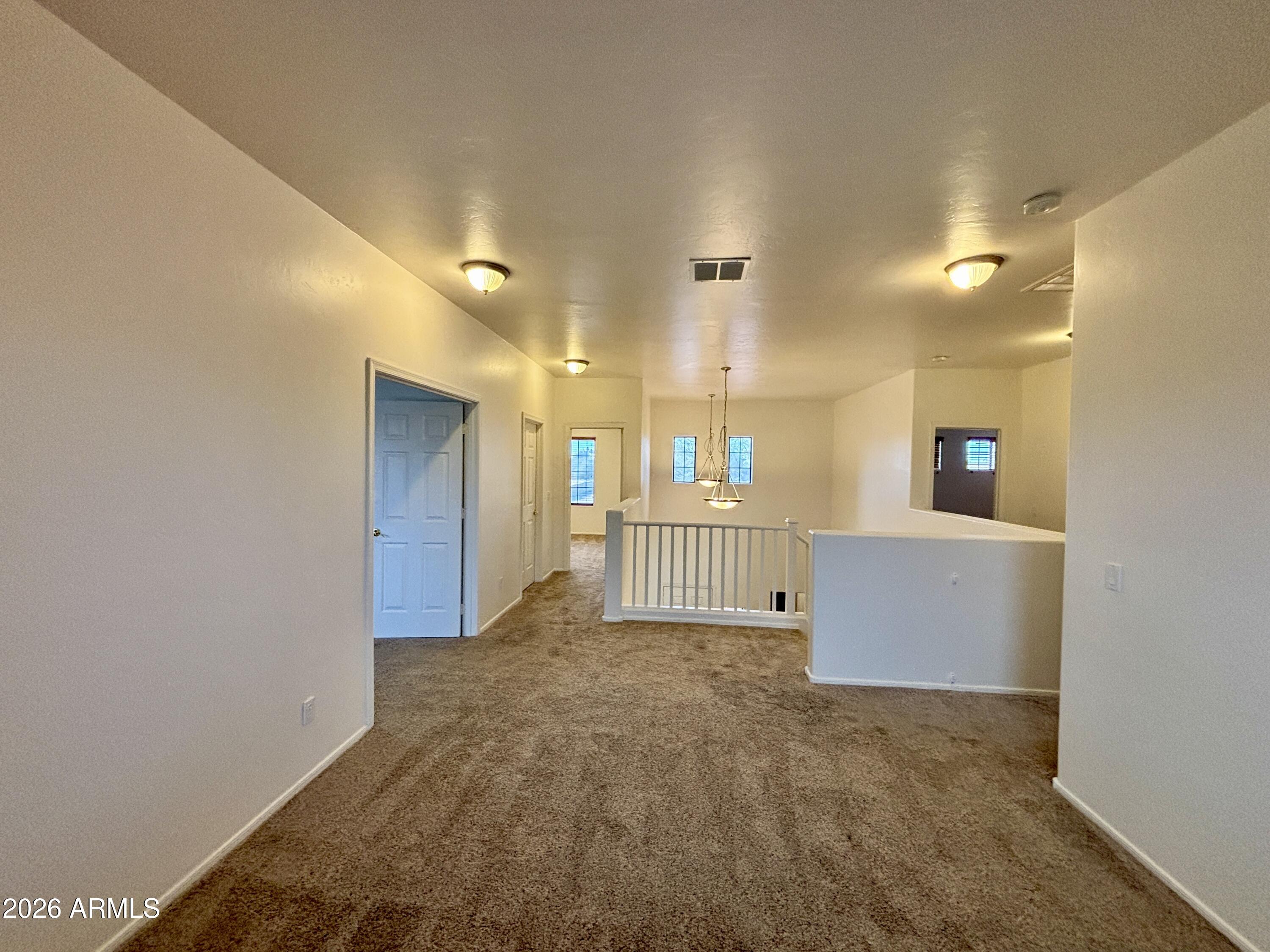 160 North Pottebaum Road Casa Grande, AZ 85122 - Photo 23 of 47 a view of a hallway with wooden floor and a living room