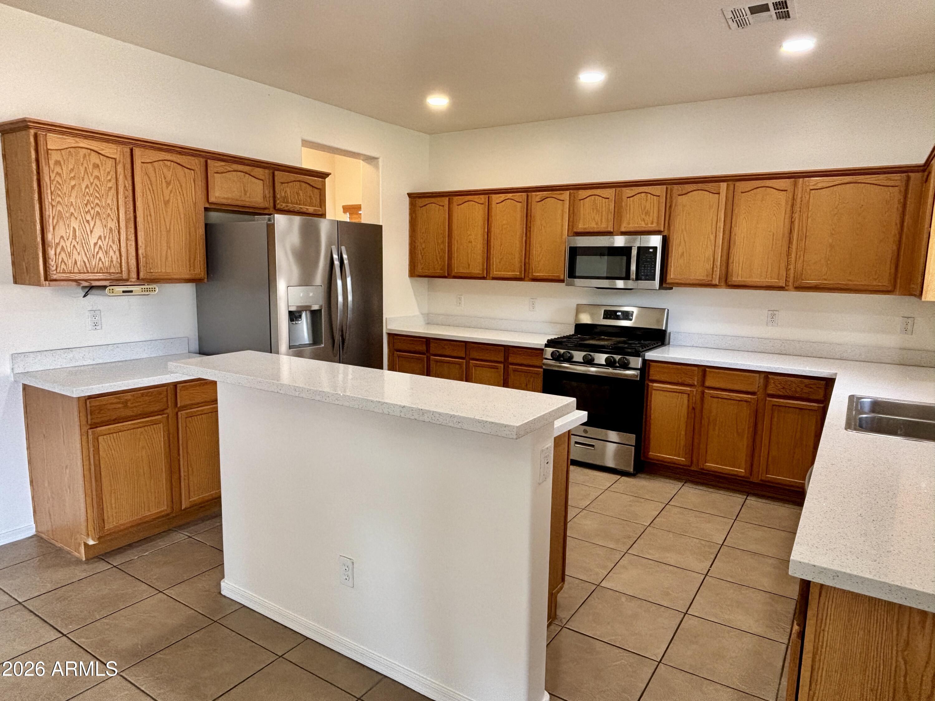 160 North Pottebaum Road Casa Grande, AZ 85122 - Photo 10 of 47 a kitchen with stainless steel appliances a refrigerator sink and microwave