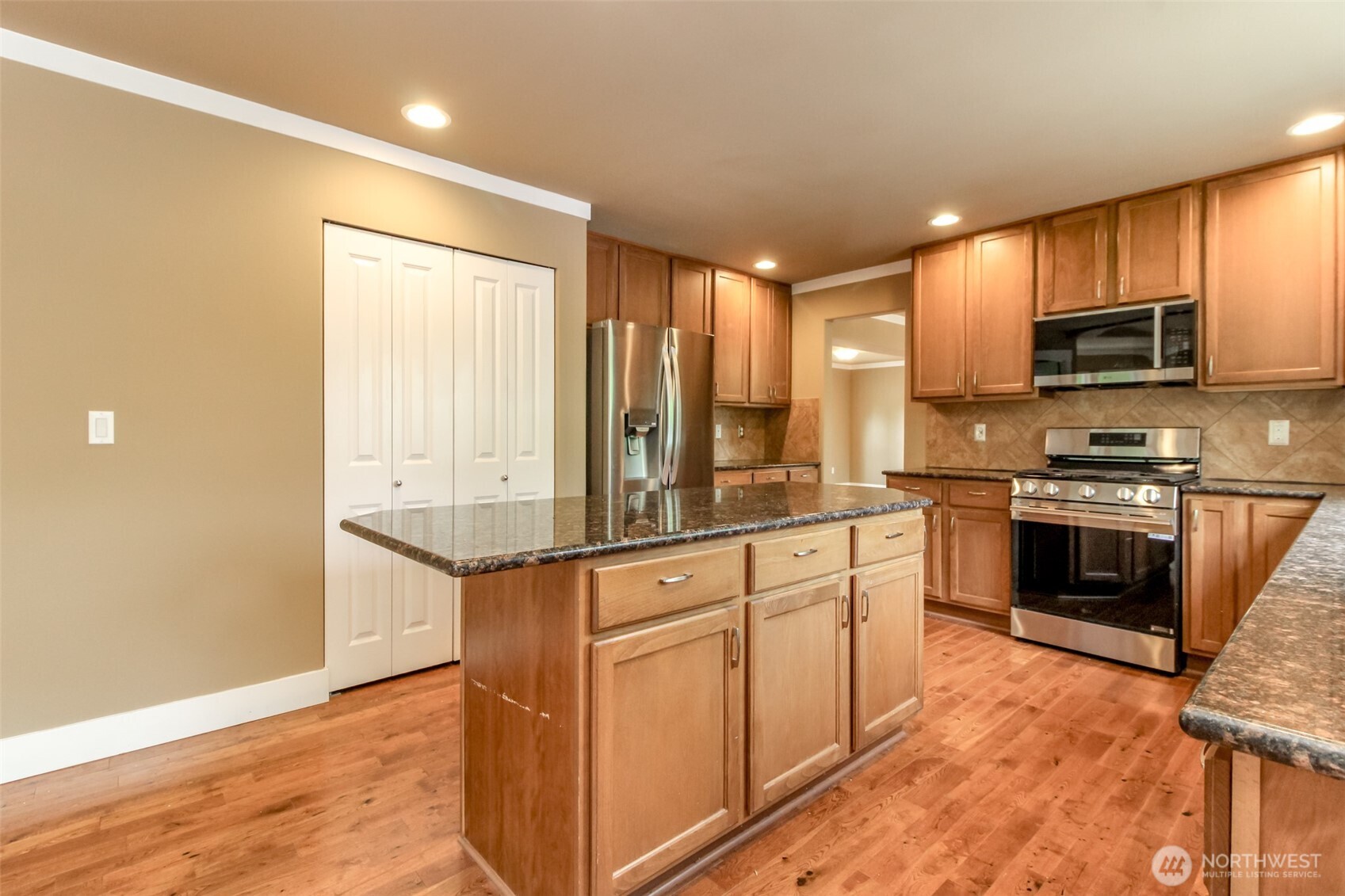 3000 South Mt Baker Boulevard Seattle, WA 98144 - Photo 14 of 40 a kitchen with stainless steel appliances granite countertop a stove top oven a sink and a refrigerator