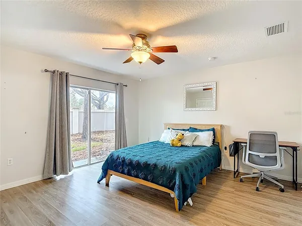 a bedroom with a bed and a chandelier