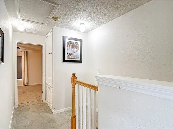 an empty room with windows and ceiling fan