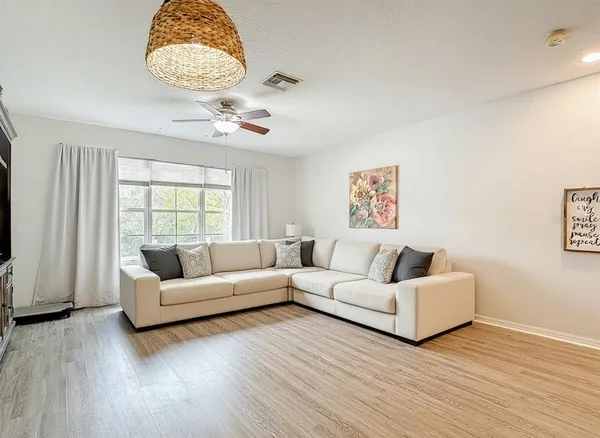 a living room with couches and a large window