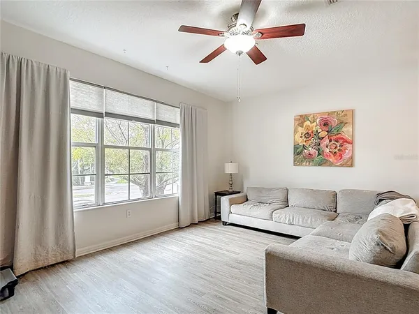 a living room with furniture and a large window