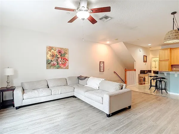 a living room with furniture and a wooden floor