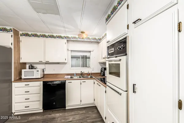 a kitchen with a sink stove and cabinets