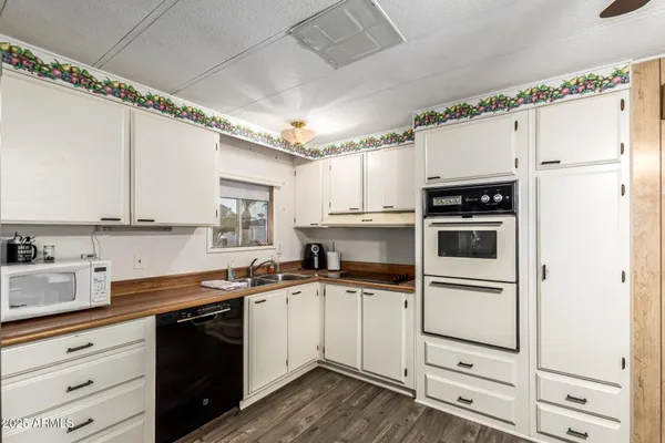 a kitchen with cabinets a sink stainless steel appliances and counter space