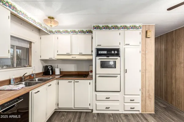 a kitchen with granite countertop a sink stove and refrigerator