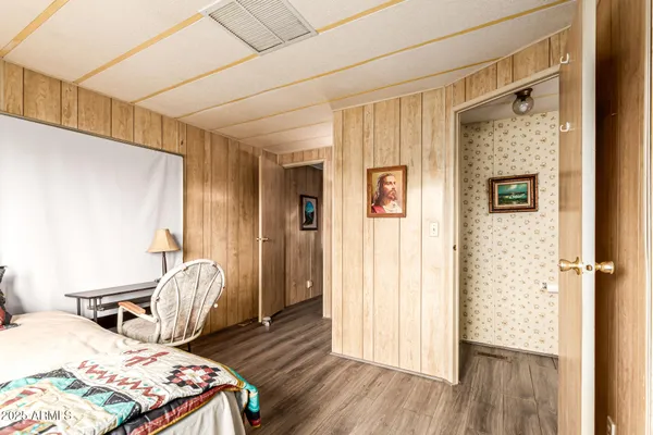 a bedroom with a bed and wooden floor