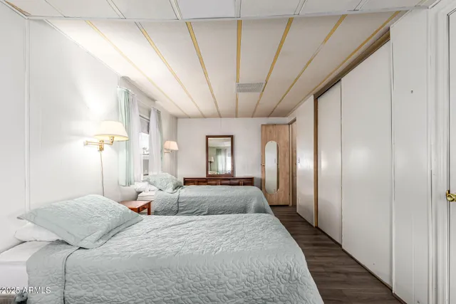 a spacious bedroom with a large bed and windows