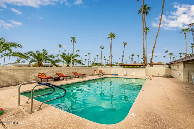 a view of a swimming pool with a lounge chair