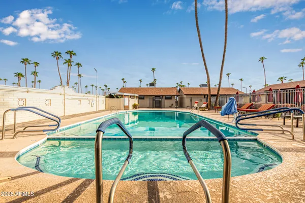 a view of a swimming pool with a lounge chairs