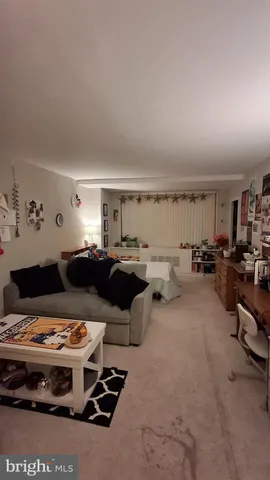 a view of a balcony with chairs and potted plants