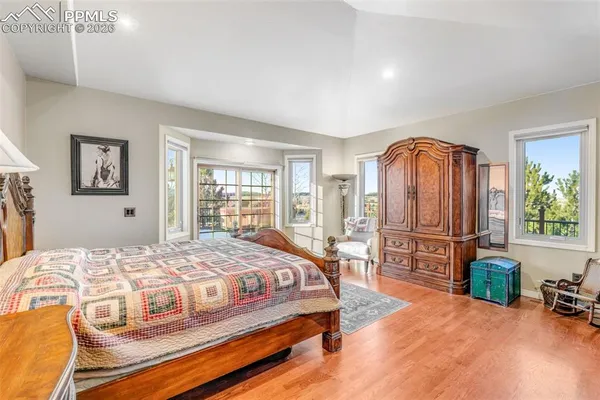 a bedroom with a bed a table and painting on the wall