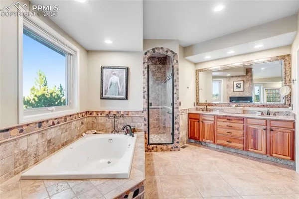 a bathroom with a tub sink and mirror