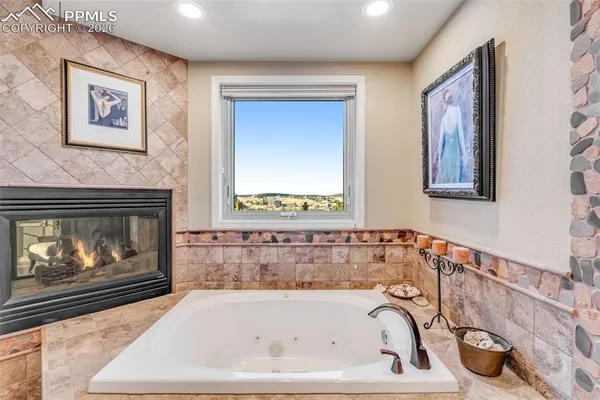 a bathroom with a bathtub and a painting
