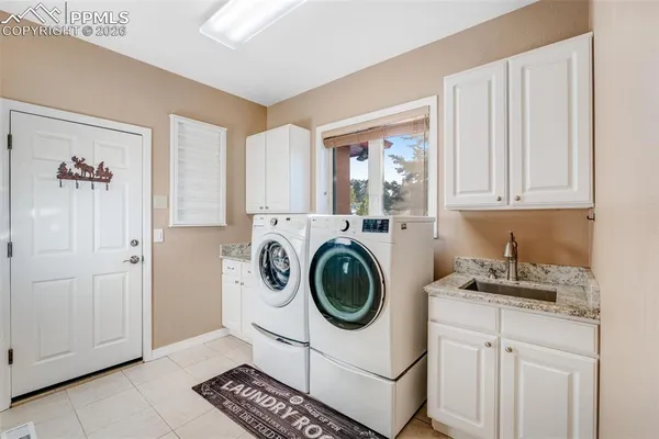 a utility room with sink dryer and washer