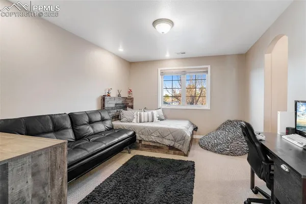 a living room with a couch and a dresser