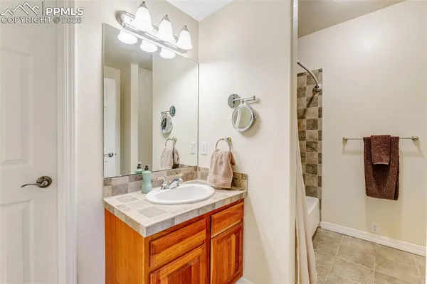 a bathroom with a sink a mirror and shower