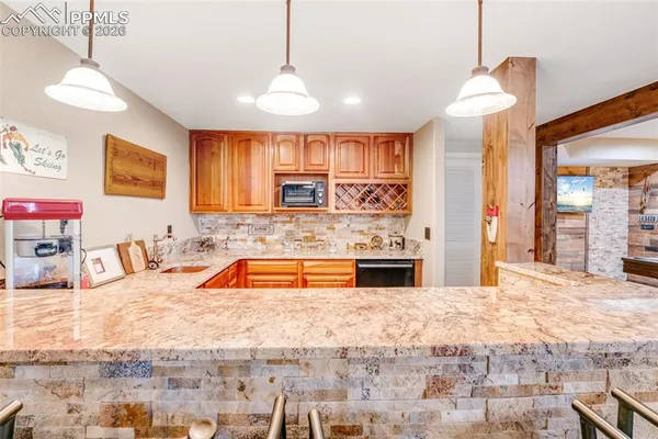a large kitchen with stainless steel appliances kitchen island granite countertop a sink and cabinets