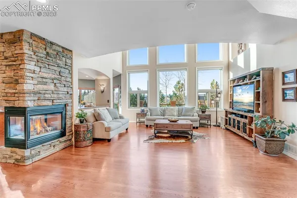 a living room with furniture flat screen tv and a fireplace
