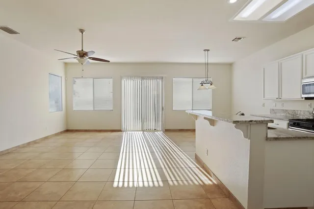 a view of kitchen with furniture and refrigerator