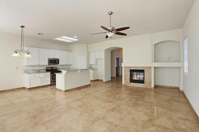a view of a kitchen with a sink and a fireplace