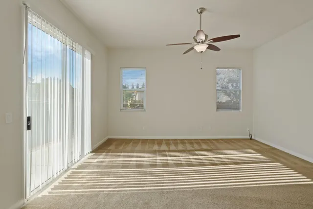 a view of a livingroom with wooden floor and a chandelier