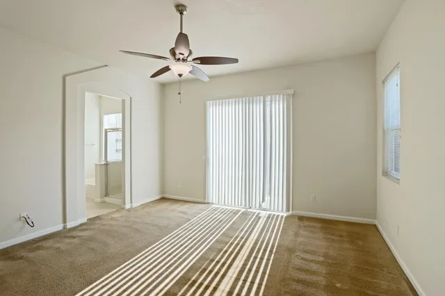 a view of a livingroom with a chandelier fan
