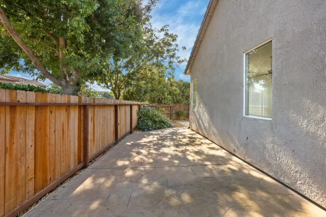a view of a pathway in a backyard of the house