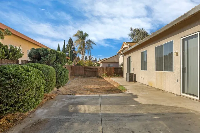 a view of a white house with a yard