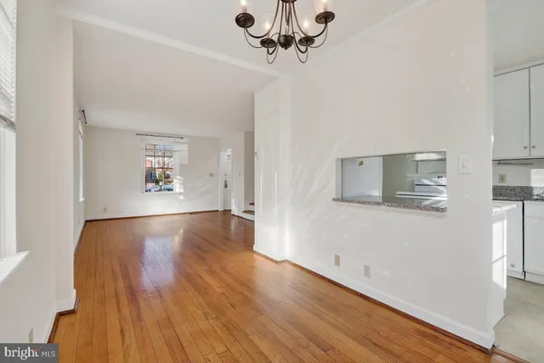 a view of a room with wooden floor and window